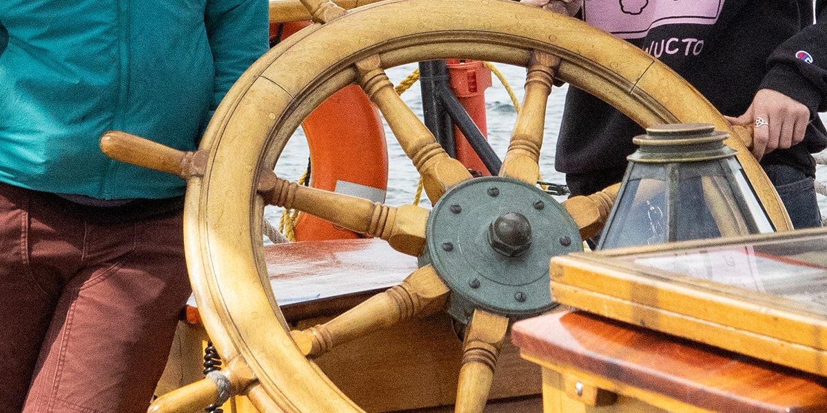 image of 2 people with a ships wheel