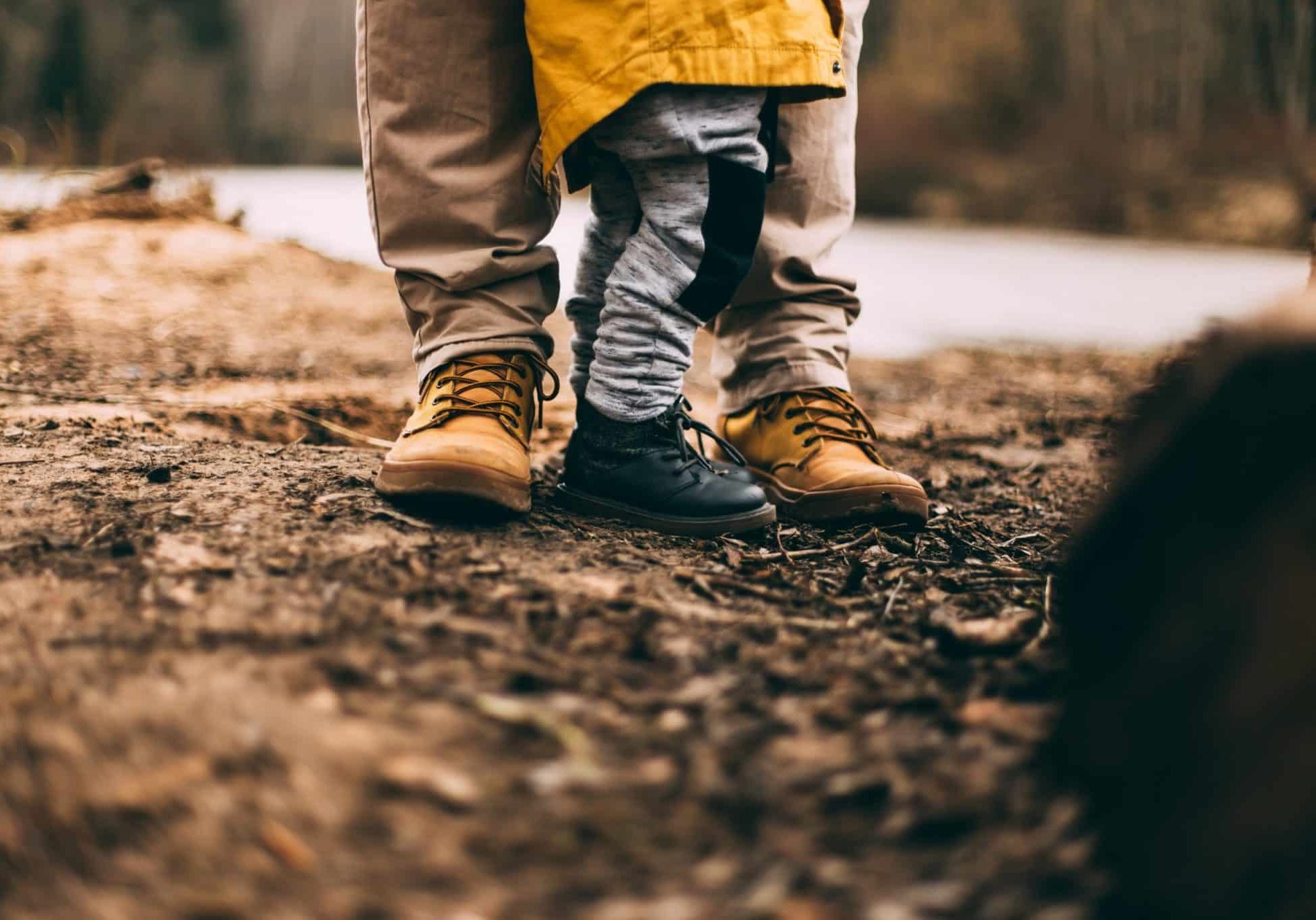 two person step on gray soil